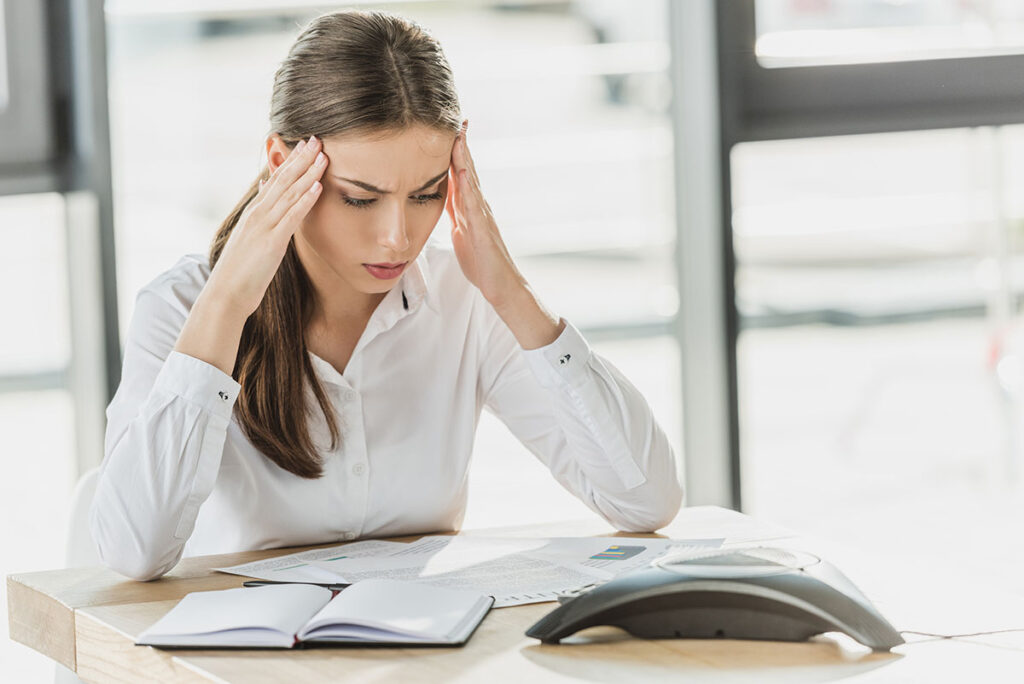 confused-young-businesswoman-doing-paperwork-at-of-E66CHCT.jpg